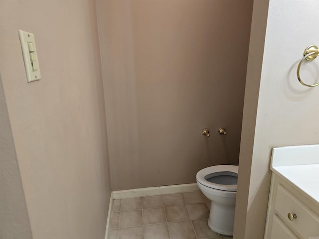 bathroom featuring tile patterned floors, toilet, vanity, and baseboards