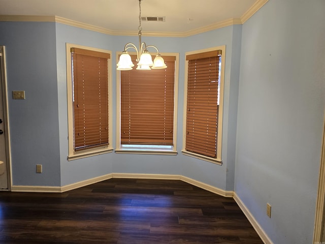 unfurnished dining area featuring visible vents, baseboards, wood finished floors, and crown molding
