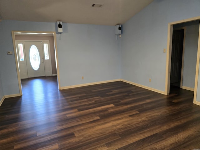 foyer with dark wood finished floors, baseboards, and visible vents