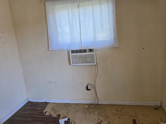 interior space featuring baseboards and a wall unit AC