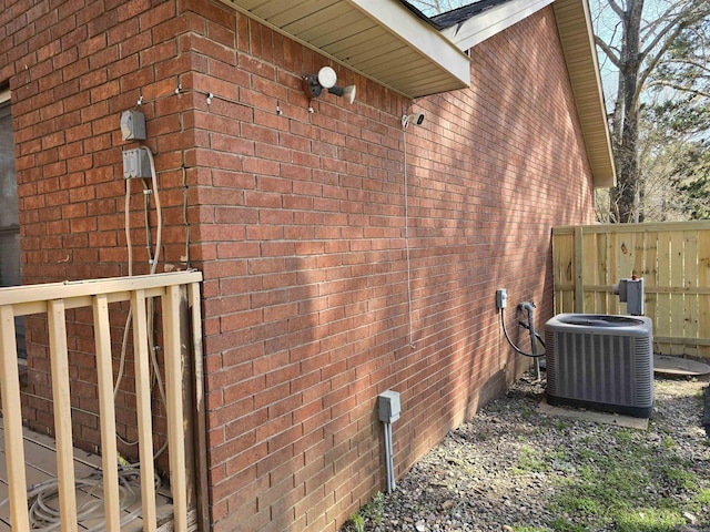 view of home's exterior featuring brick siding and central AC unit