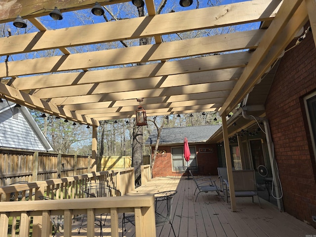 deck featuring outdoor dining space, fence, and a pergola