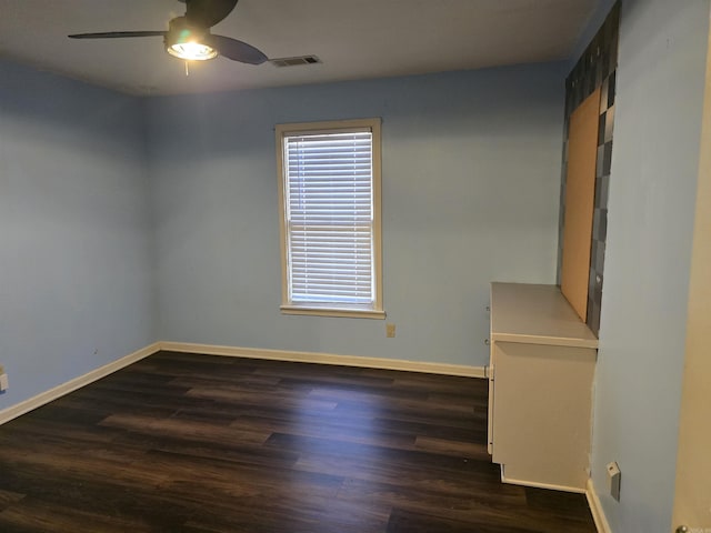spare room with visible vents, baseboards, a ceiling fan, and wood finished floors