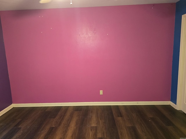 empty room with a ceiling fan, baseboards, and wood finished floors