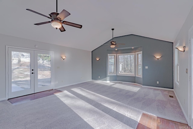 unfurnished living room featuring baseboards, ceiling fan, lofted ceiling, carpet flooring, and french doors
