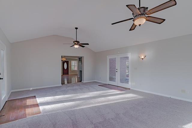 unfurnished living room with light carpet, french doors, ceiling fan, and vaulted ceiling