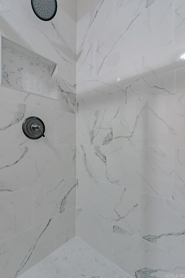bathroom with tiled shower