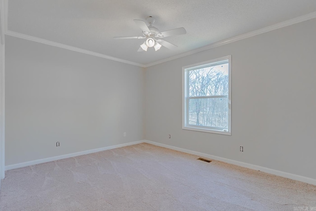 unfurnished room featuring visible vents, baseboards, crown molding, and a ceiling fan