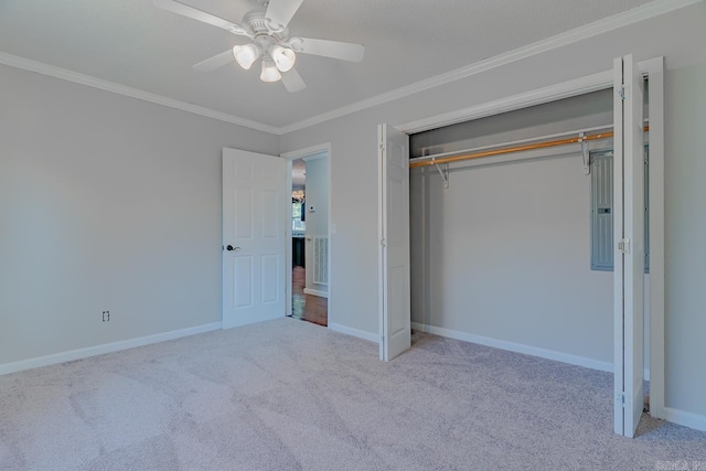 unfurnished bedroom featuring a closet, baseboards, carpet, and ornamental molding