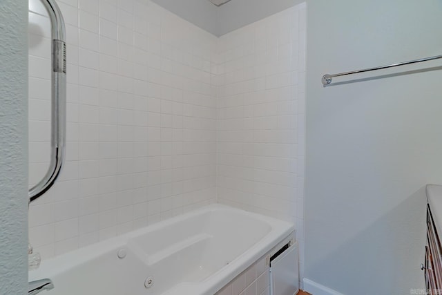 bathroom with a tub with jets