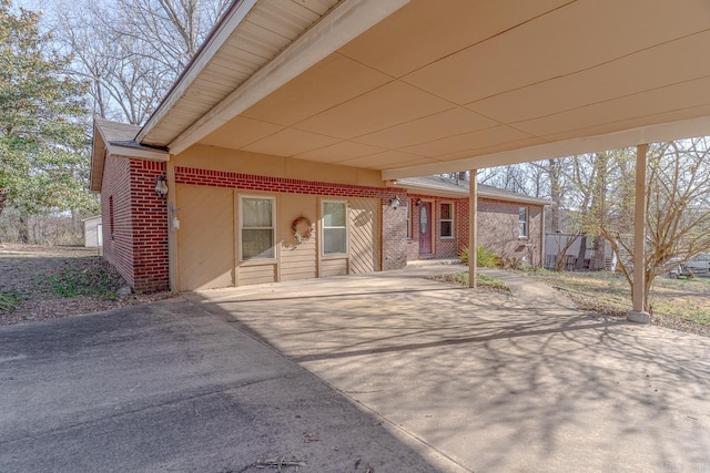 view of patio with a carport and concrete driveway