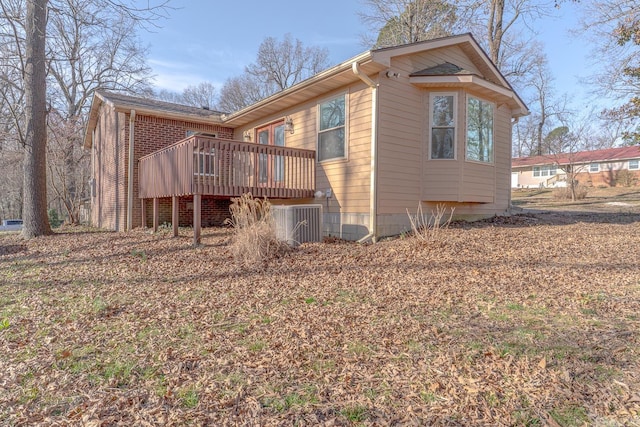 view of property exterior featuring a deck and cooling unit
