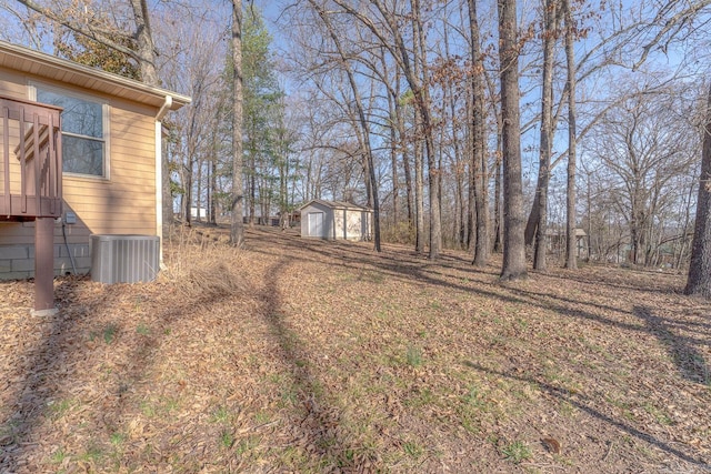 view of yard with a shed, cooling unit, and an outdoor structure