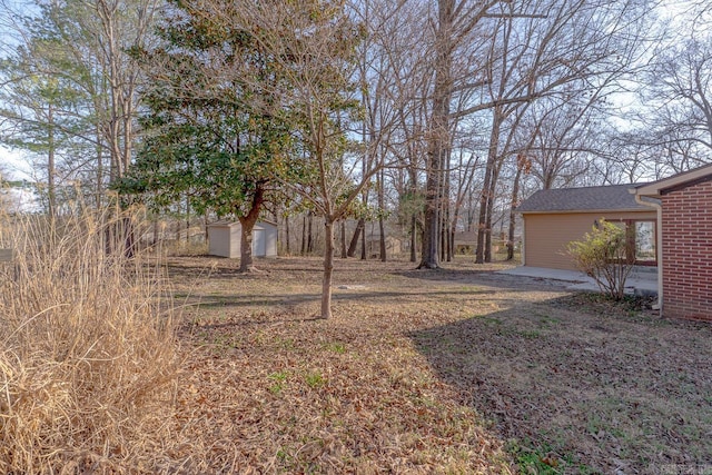 view of yard featuring an outbuilding and a shed