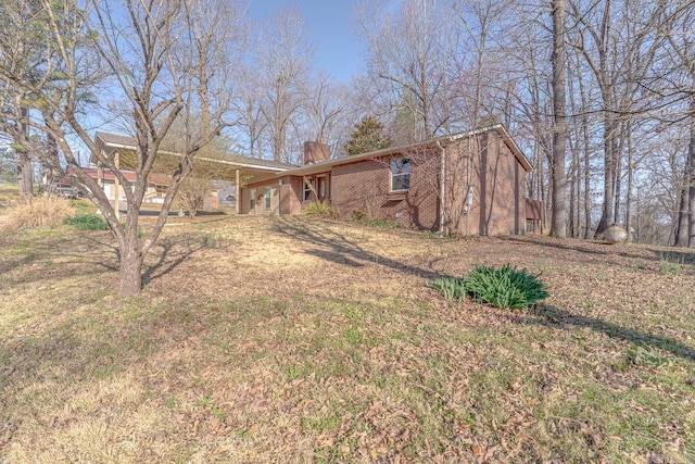 view of front of house featuring a front lawn and a chimney