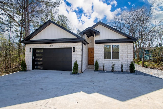 13505 Alexander Rd, Alexander, AR 72002 - view of front of home featuring brick siding, board and batten siding, concrete driveway, and a garage