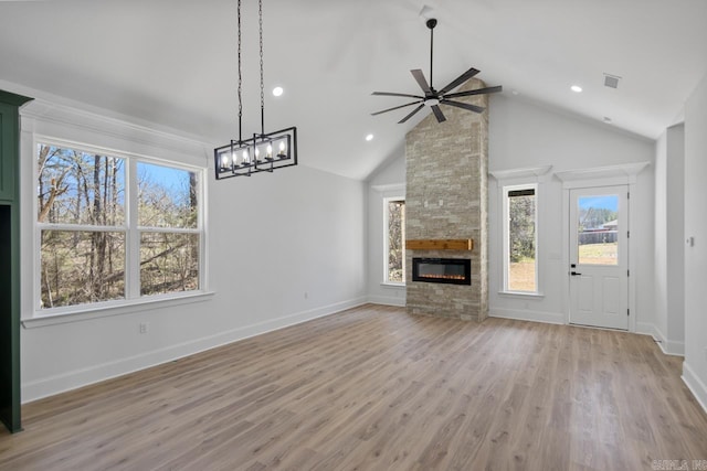 13505 Alexander Rd, Alexander, AR 72002 - unfurnished living room with visible vents, baseboards, ceiling fan, a stone fireplace, and light wood-type flooring