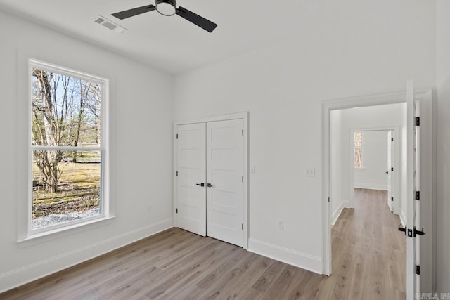 13505 Alexander Rd, Alexander, AR 72002 - unfurnished bedroom featuring multiple windows, light wood-style floors, and visible vents