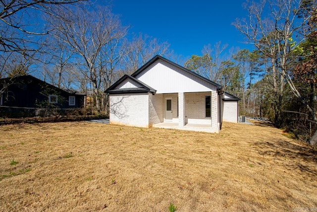 13505 Alexander Rd, Alexander, AR 72002 - rear view of house with a yard, brick siding, and a patio area