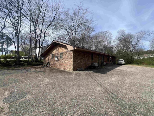 view of side of home featuring brick siding