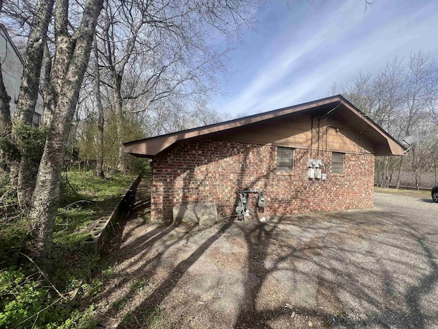 view of side of property featuring brick siding