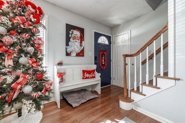 2304 Forrest Park Dr, Arkadelphia, AR 71923 - entryway featuring stairway, a textured ceiling, and wood finished floors