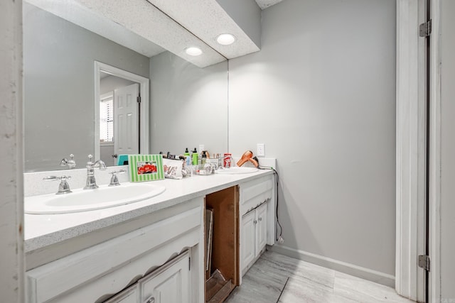 2304 Forrest Park Dr, Arkadelphia, AR 71923 - full bathroom featuring double vanity, baseboards, and a sink