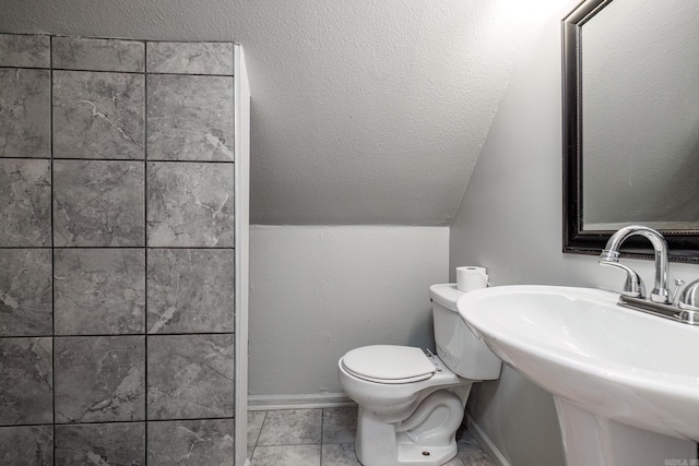 2304 Forrest Park Dr, Arkadelphia, AR 71923 - bathroom featuring baseboards, a sink, vaulted ceiling, tile patterned floors, and toilet