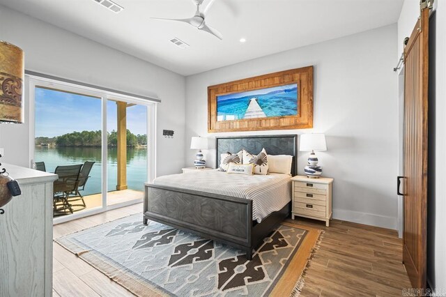 1601 Marion Anderson Rd, Hot Springs, AR 71913 - bedroom featuring access to exterior, visible vents, baseboards, a barn door, and wood finished floors