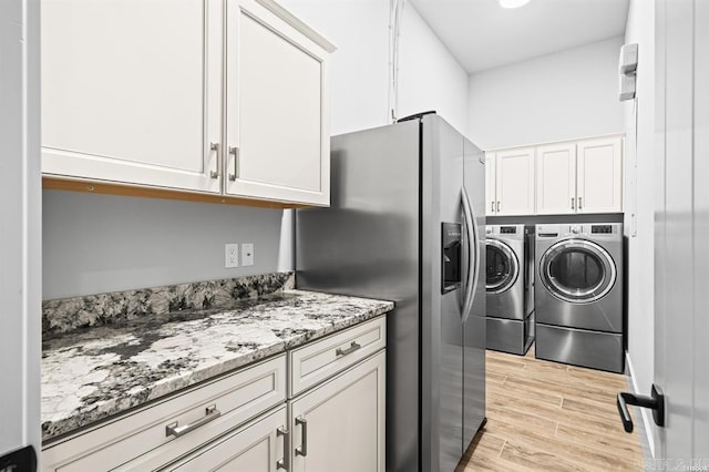 1601 Marion Anderson Rd, Hot Springs, AR 71913 - washroom with washing machine and clothes dryer, cabinet space, and light wood-type flooring