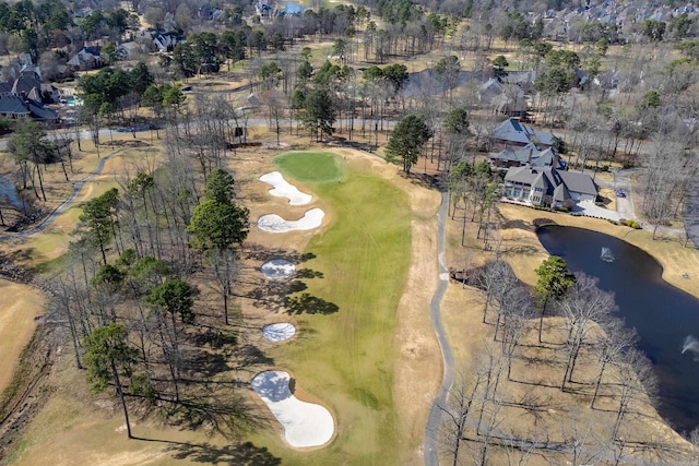 birds eye view of property featuring a water view and view of golf course