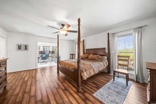bedroom with a textured ceiling, wood finished floors, and a ceiling fan