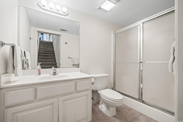 bathroom with visible vents, toilet, a stall shower, and tile patterned flooring