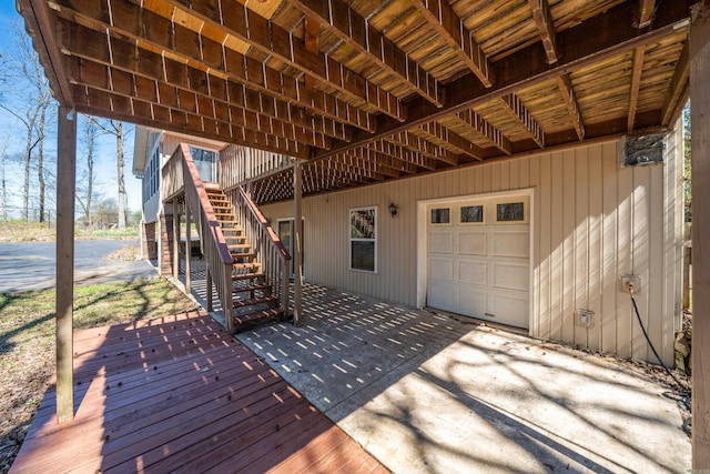 deck with stairs and a garage