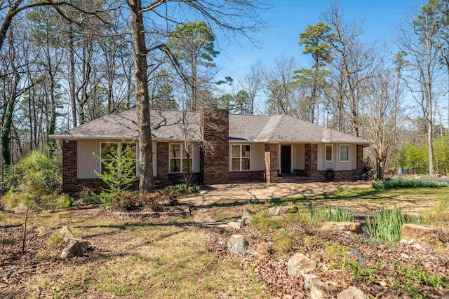 single story home featuring brick siding