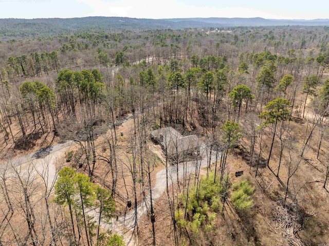 birds eye view of property featuring a view of trees