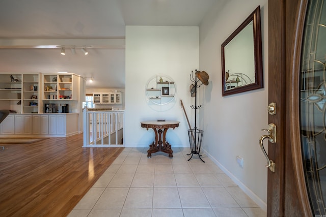 entryway featuring baseboards and light wood-style flooring