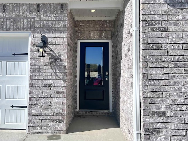 property entrance featuring brick siding