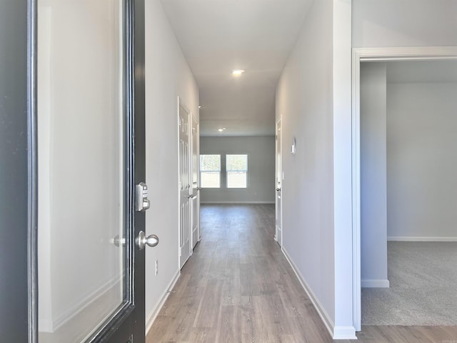 hall with recessed lighting, baseboards, and wood finished floors