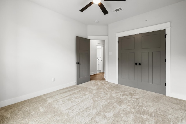 unfurnished bedroom featuring carpet floors, baseboards, a closet, and a ceiling fan