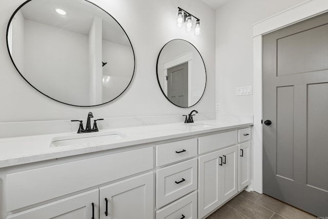 full bath with double vanity, recessed lighting, and tile patterned floors
