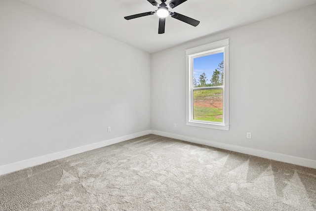 unfurnished room featuring carpet floors, baseboards, and a ceiling fan
