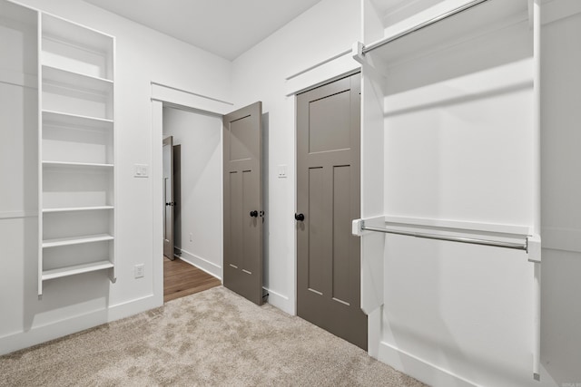 walk in closet with carpet floors