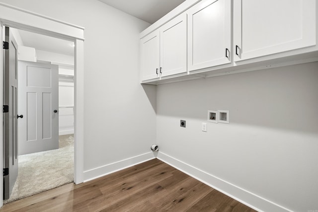 washroom with cabinet space, hookup for an electric dryer, dark wood-style flooring, baseboards, and washer hookup