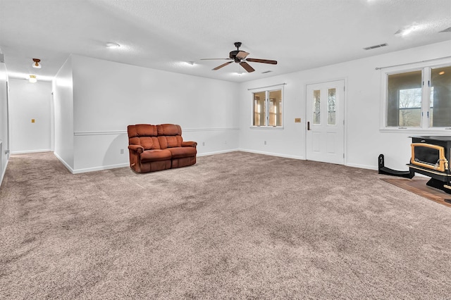 120 Lisa Blvd, Greers Ferry, AR 72067 - sitting room featuring visible vents, a wood stove, ceiling fan, and carpet flooring