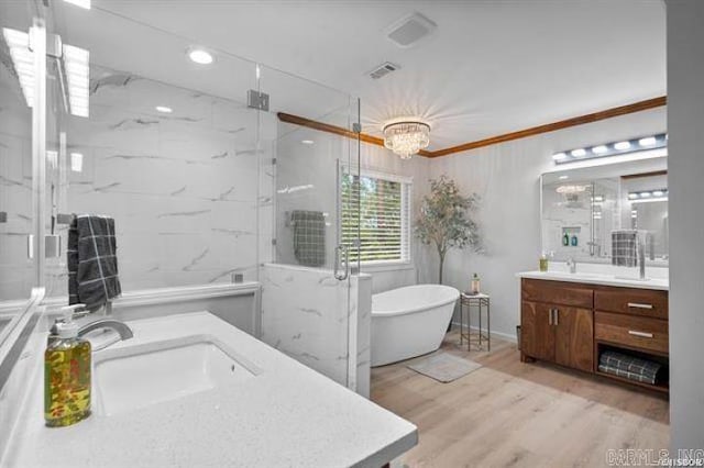 103 River Bend Rd, Hot Springs, AR 71913 - bathroom featuring vanity, wood finished floors, a marble finish shower, a freestanding tub, and a chandelier