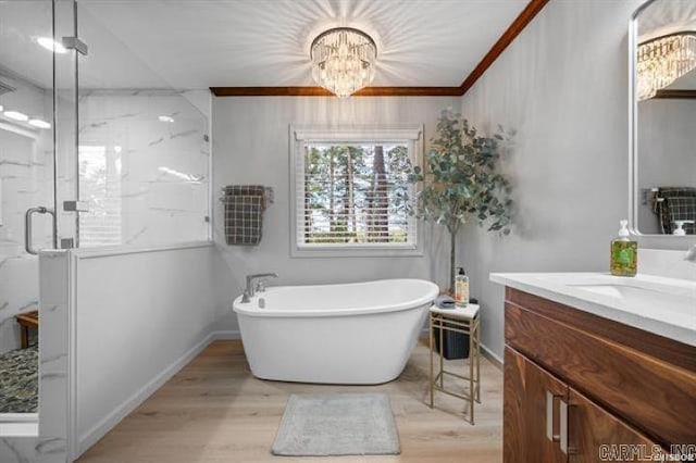103 River Bend Rd, Hot Springs, AR 71913 - bathroom featuring a notable chandelier, a stall shower, wood finished floors, a soaking tub, and vanity