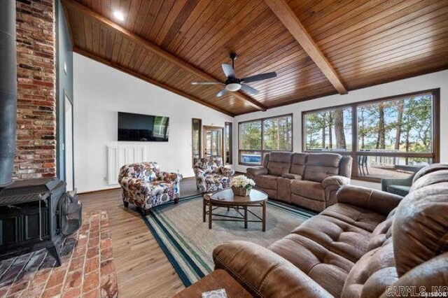 103 River Bend Rd, Hot Springs, AR 71913 - living area featuring ceiling fan, beamed ceiling, wood ceiling, a wood stove, and wood finished floors
