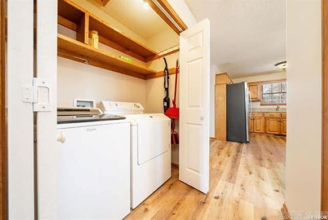 103 River Bend Rd, Hot Springs, AR 71913 - clothes washing area featuring washer and clothes dryer, laundry area, and light wood-type flooring