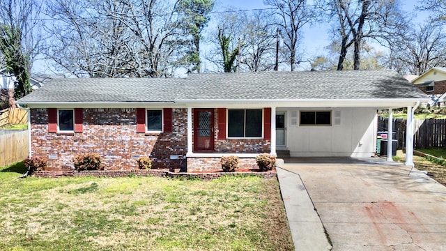 ranch-style home featuring fence, concrete driveway, a front lawn, a carport, and crawl space